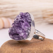 Amethyst ring on a stone with a blurred natural background
